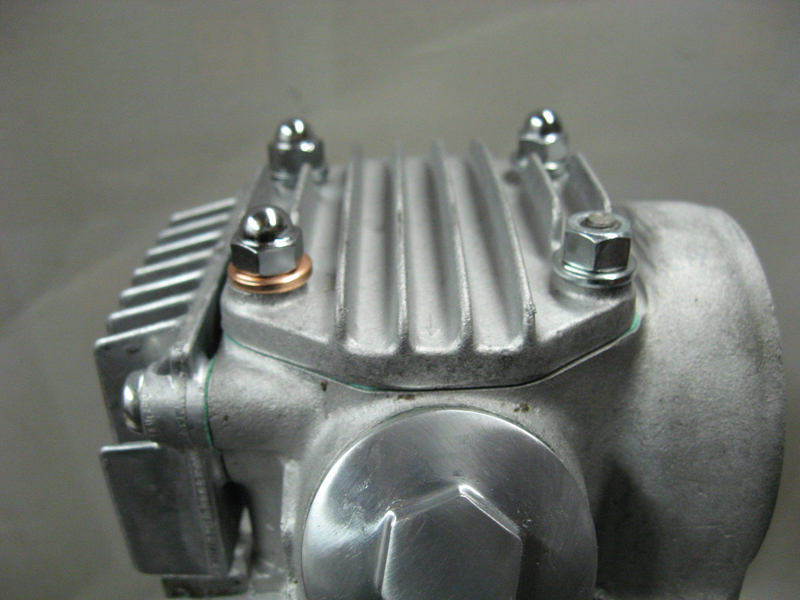 CU Close up of the way Honda wants the fasteners on the head_ Yes the open nut goes there_ The copper washer seals the oil passage under it.